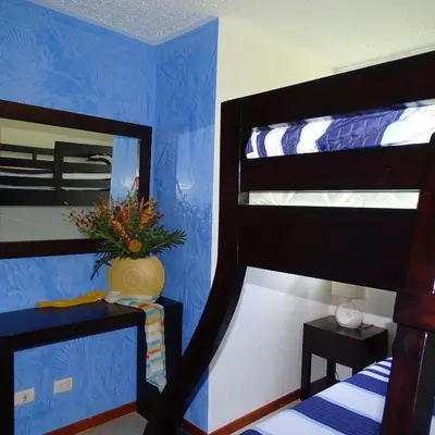 a bedroom with a bunk bed and a mirror at 3Room Jaco Condos in Jacó