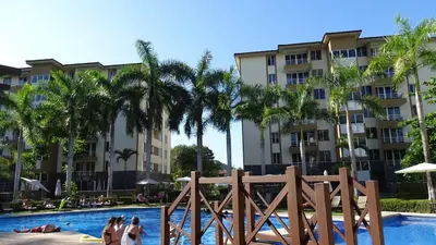 a group of people in the pool at a resort at 3Room Jaco Condos in Jacó