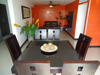 a dining room with a table and chairs at 3Room Jaco Condos in Jacó