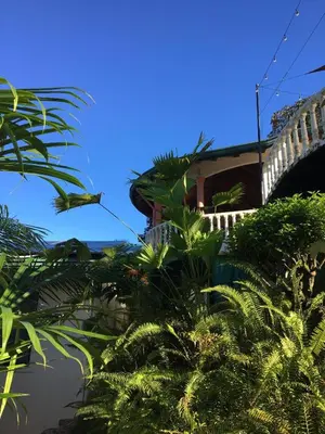 a building with a bridge and some palm trees at Mango Tree Villas in Coronado