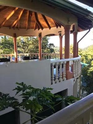 a porch of a house with a wooden roof at Mango Tree Villas in Coronado