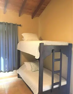 two bunk beds in a room with a ladder at Mango Tree Villas in Coronado