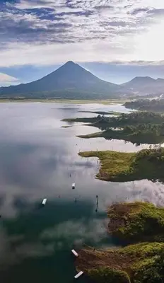 an aerial view of a large body of water with a mountain at Sunset Inn Arenal B&B in Fortuna
