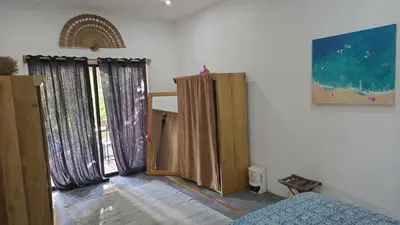 a room with some wooden doors and curtains at La Sana Surf Hotel, Playa Carmen in Santa Teresa Beach