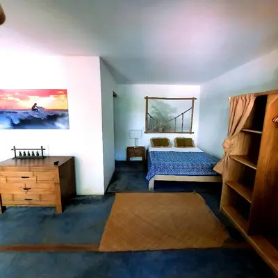 a bedroom with a bed and a dresser in it at La Sana Surf Hotel, Playa Carmen in Santa Teresa Beach