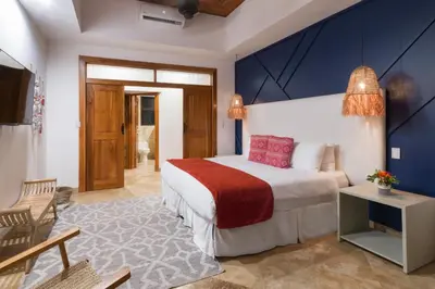 a bedroom with a bed and a blue wall at Casa Anjali by Sandglass in Manuel Antonio
