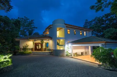 a large house with a driveway in front of it at Casa Anjali by Sandglass in Manuel Antonio