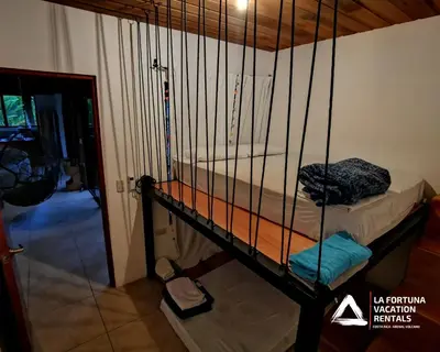 a cage with two beds in a room at Villa Cocos la Fortuna in Fortuna