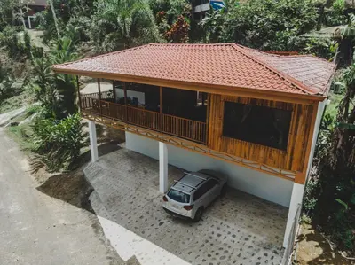 a small house with a car parked in front of it at Villa Cocos la Fortuna in Fortuna