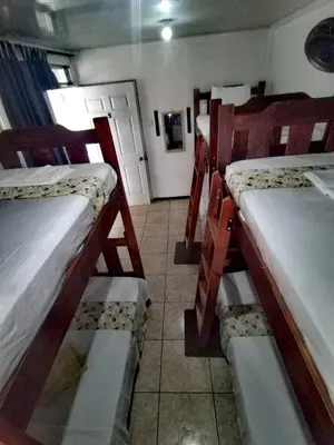 a room with three bunk beds in a room at Lajuela BnB & Hostel in Alajuela City