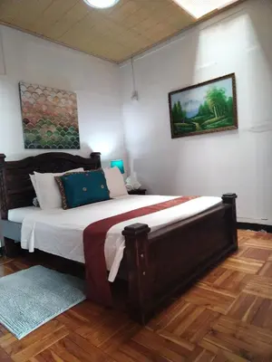 a bedroom with a large bed in a room at Lajuela BnB & Hostel in Alajuela City
