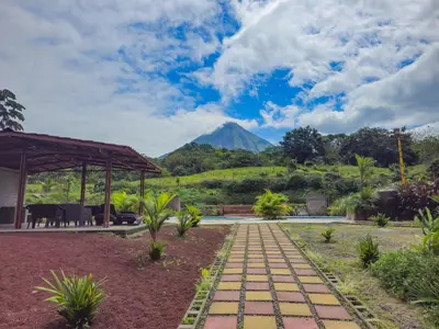 a house with a view of a mountain at Confort Arenal in Fortuna