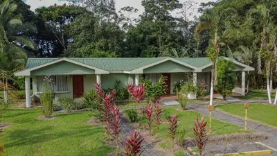 a house with a green roof at Confort Arenal in Fortuna