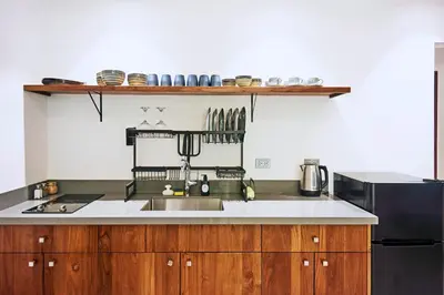 a kitchen with a sink and a refrigerator at NATURA Loft Garden in Santa Teresa Beach