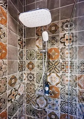 a shower in a bathroom with tiles on the floor at NATURA Loft Garden in Santa Teresa Beach
