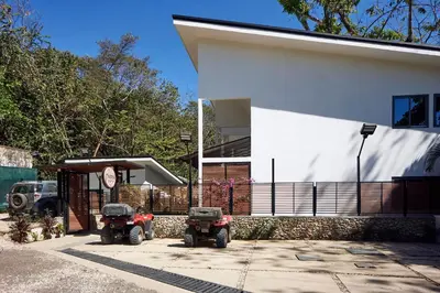 two atvs parked in front of a house at NATURA Loft Garden in Santa Teresa Beach