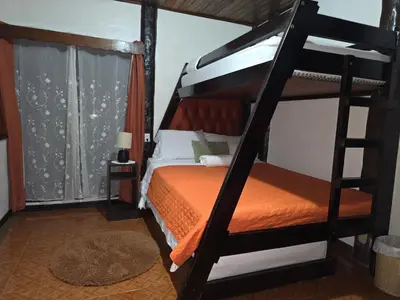 a bedroom with a bunk bed with an orange mattress at Casa Irazú in Cartago
