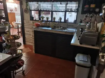 a kitchen with a sink and a counter top at Casa Irazú in Cartago