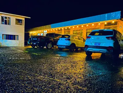 a parking lot with cars parked in front of a building at Cabinas Selva Verde in Monteverde Costa Rica