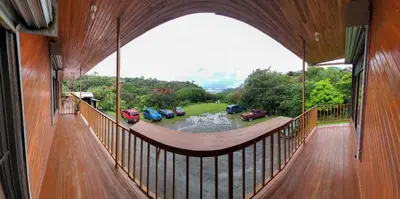 a large balcony with a view of a parking lot at Cabinas Selva Verde in Monteverde Costa Rica