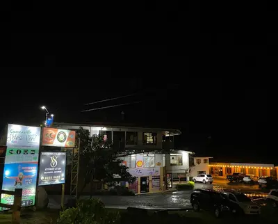 a building with a car parked in a parking lot at night at Cabinas Selva Verde in Monteverde Costa Rica