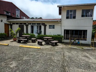 a group of picnic tables in front of a building at Cabinas Selva Verde in Monteverde Costa Rica