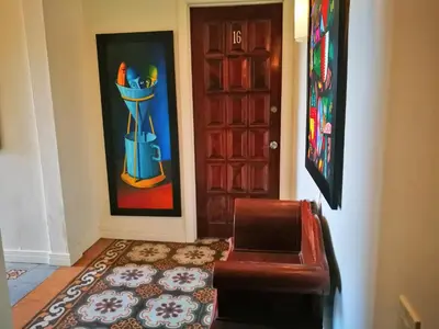 a living room with a couch and a door at Hotel Casa 69 in San José