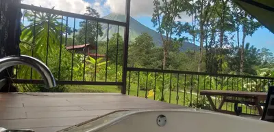 a bathroom with a tub and a view of a mountain at Tropical Suites & Villas in Fortuna