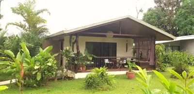 a house with a balcony with a yard at Tropical Suites & Villas in Fortuna