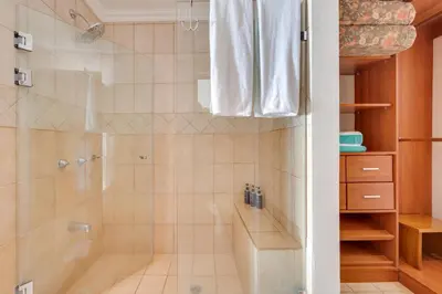 a bathroom with a shower with a glass door at Oceanica 804 in Playa Flamingo