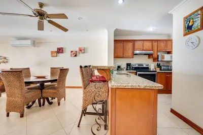 a kitchen and dining room with a table and chairs at Oceanica 804 in Playa Flamingo