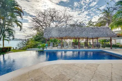 a villa with a swimming pool and a pavilion at Oceanica 804 in Playa Flamingo