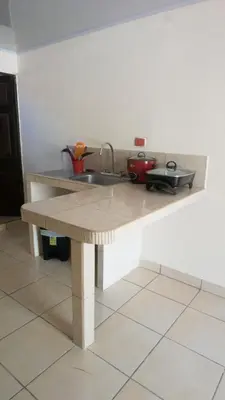 a kitchen with a sink and a counter top at Apartamento Equipado Morpho CR. in Quepos