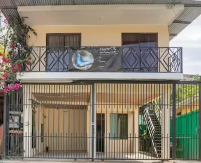 a building with a balcony with a sign on it at Apartamento Equipado Morpho CR. in Quepos
