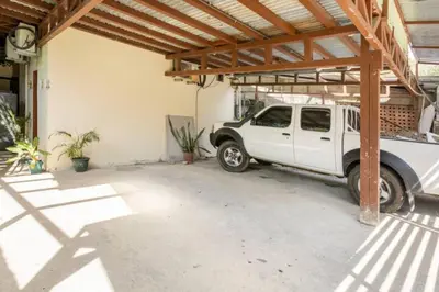 a white truck parked in a garage at Apartamento Equipado Morpho CR. in Quepos