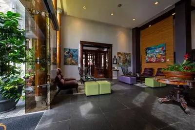 a lobby with chairs and a table in a building at Grano de Oro Hotel in San José