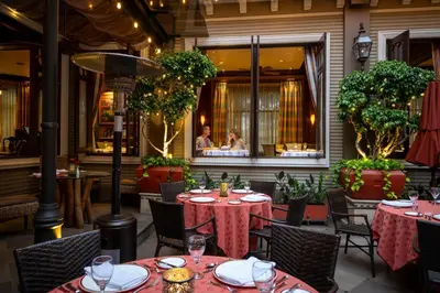 a restaurant with tables and chairs and people in a window at Grano de Oro Hotel in San José