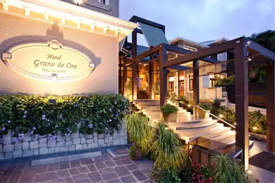 a building with a sign that reads first gina be one at Grano de Oro Hotel in San José