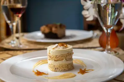 a piece of cake on a white plate on a table at Grano de Oro Hotel in San José