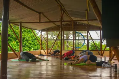 a group of people doing yoga in a tent at Essence Arenal Spa & Yoga in El Castillo de La Fortuna