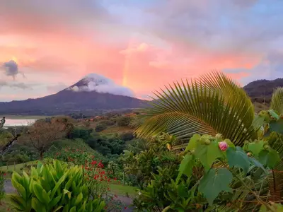 a view of a mountain with a rainbow in the sky at Essence Arenal Spa & Yoga in El Castillo de La Fortuna