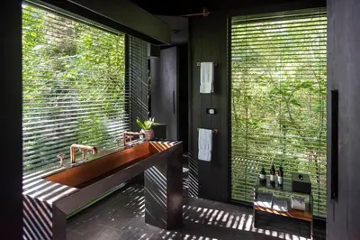 a bathroom with a sink and a large window at Rio Perdido Hotel & Thermal River in Fortuna