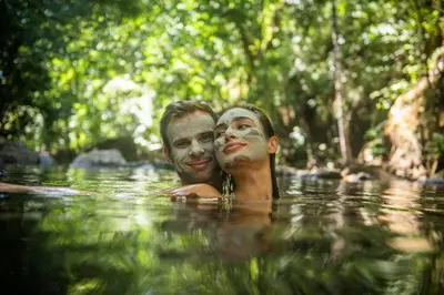 two people in the water with masks on their faces at Rio Perdido Hotel & Thermal River in Fortuna