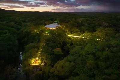 an aerial view of a building in the middle of a forest at Rio Perdido Hotel & Thermal River in Fortuna