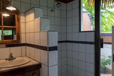 a bathroom with a sink and a mirror at Hotel Vista de Olas in Santa Teresa Beach