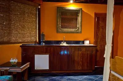 a bathroom with a sink and a window and a table at Hotel Vista de Olas in Santa Teresa Beach