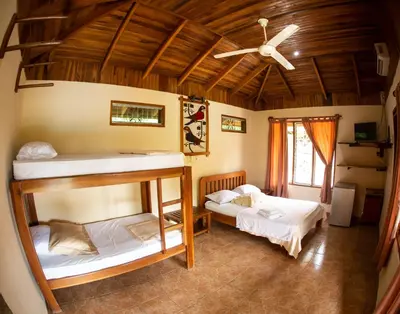 two bunk beds in a room with a ceiling at Hotel Ritmo Tropical - Pool and Breakfast in Santa Teresa Beach