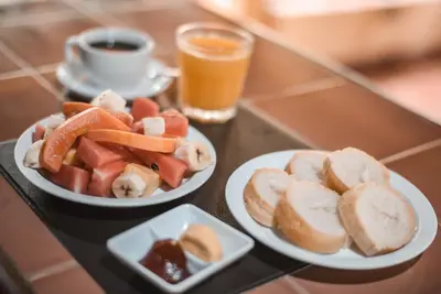 two plates of food on a table with a cup of coffee at Hotel Ritmo Tropical - Pool and Breakfast in Santa Teresa Beach