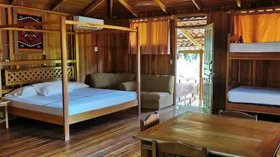 a bedroom with two bunk beds and a table at Hotel Ritmo Tropical - Pool and Breakfast in Santa Teresa Beach