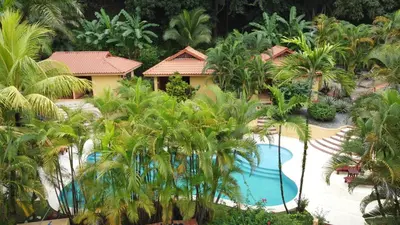 an aerial view of a resort with a pool and palm trees at Hotel Ritmo Tropical - Pool and Breakfast in Santa Teresa Beach